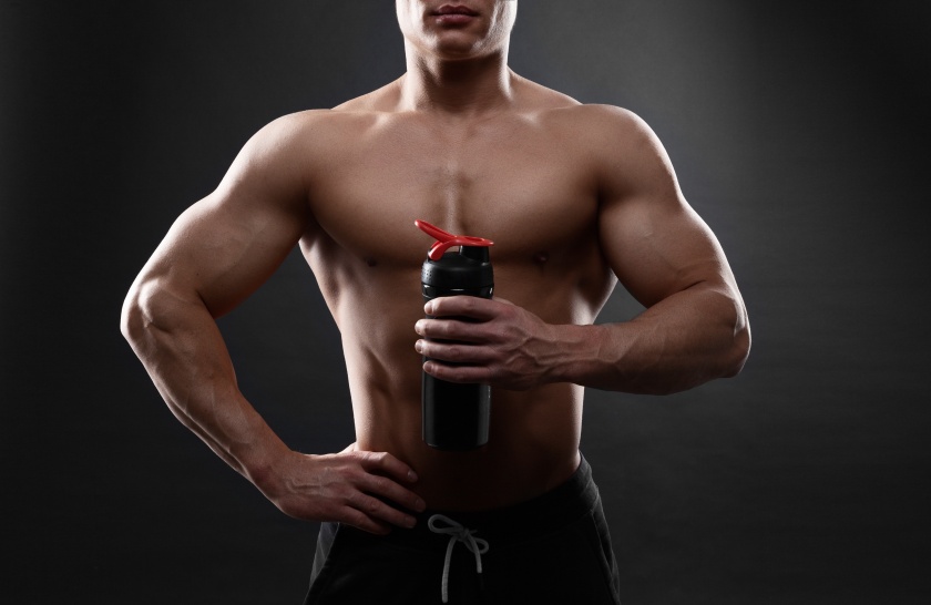 Man bodybuilder is holding a shaker for drinks